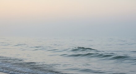 Fototapeta premium Serene ocean waves gently roll under soft dawn light. AI Generated