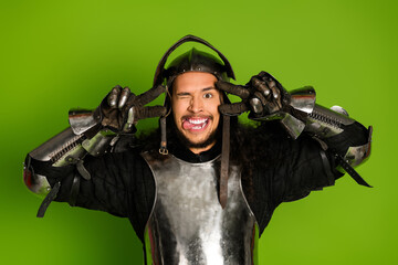 Playful Knight in Shining Armor Against a Green Background Expressing Joy