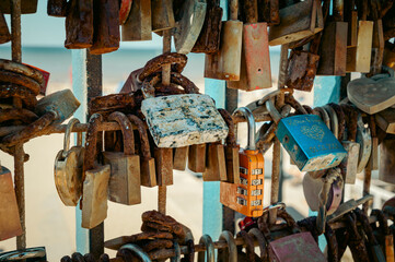 Rusty Love Locks Attached to Railings on a Bridge