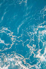 Close-up of turquoise ocean water with foam and waves