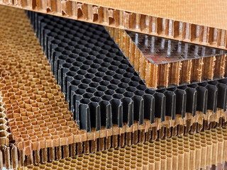 Layers of carbon fiber and honeycomb materials displaying their unique textures and structural...
