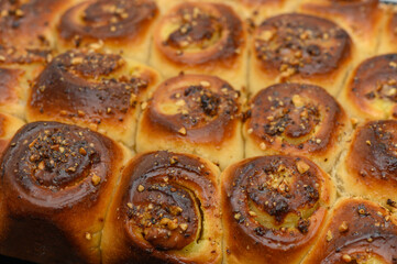 Freshly baked cinnamon rolls with a golden crust and a nutty topping, perfect for a cozy morning moment in the kitchen