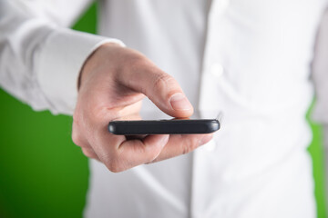 Male hand showing black mobile phone.