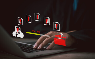 Data security warning and file error concept. Businessman uses laptop while warning signs and red...