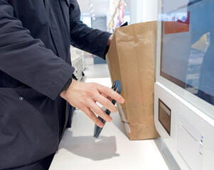 Self-checkouts or self-service checkouts,man paying for the purchases  in supermarkets