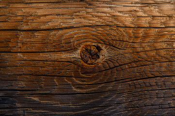 Warm tones of aged wood reveal natural patterns in a rustic setting during golden hour light