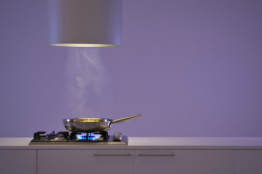 Steaming Cast Iron Frying Pan on Gas Stove with Purple Background