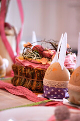 Easter pink handmade bunnies decorate the holiday table, Easter table setting 