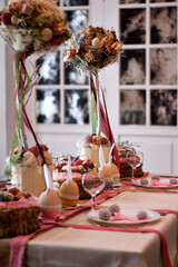 Easter table setting with round topiary trees and ribbons in pink colors