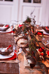 Easter table setting with red décor and branches