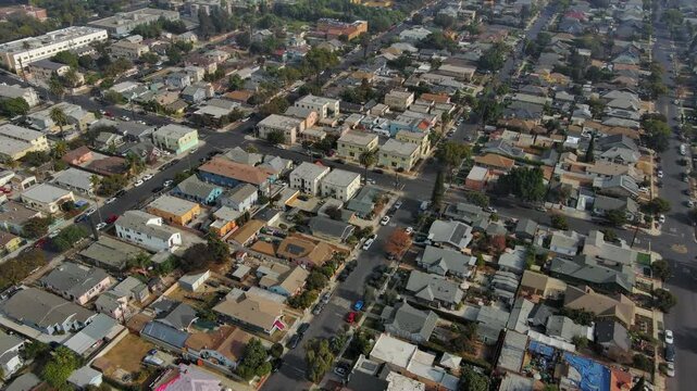 Panorama by aerial view of the South Los Angeles. Houses, buildings, cars, trees along the streets. Typical urban residential area of Los Angeles. Drone shot. Real estate concept