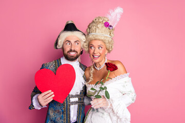 Playful Couple in Vintage Royal Costume Posing with Heart and Rose on Pink Background