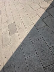 Fototapeta premium Diagonal Shadow on Stone Paved Road