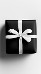 Black gift box with white ribbon on neutral background, top view