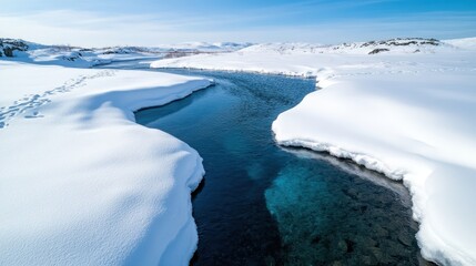 A picturesque view of a winding river embraced by untouched snow blankets, embodying the tranquil essence of winter within a remote natural setting.
