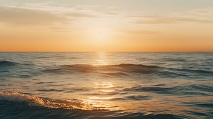 Fototapeta premium Sunset over calm ocean waves at golden hour