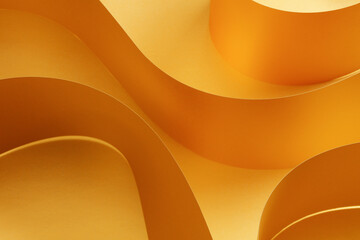 Golden printing paper sheets. Geometric wave abstract design concept. Selective focus on the high...