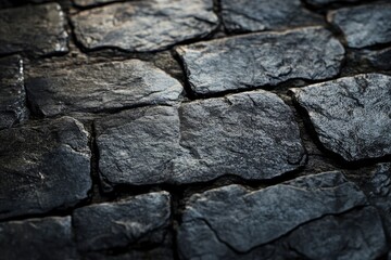 Fototapeta premium Dark Stone Wall Texture Background Featuring Rectangular Rock Tiles