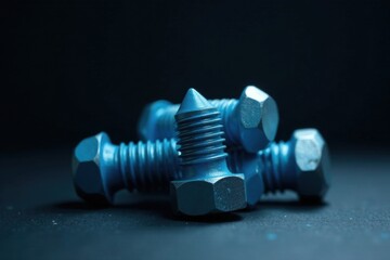Close-up view of several metallic fasteners with a blue finish, exhibiting intricate details and a dark background