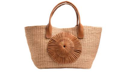 Close up of a woven straw tote bag with leather handles and a circular design element on it