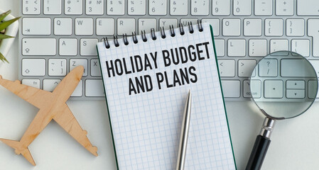 A small notebook with a pen and an airplane on it