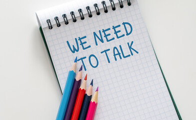 A notebook with the words We Need to Talk written on it