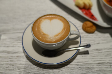 Heart-shaped latte art creates a warm atmosphere in a cozy cafe setting in early morning