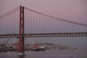 Breathtaking suspension bridge Lisbon skyline views from balcony of modern cruiseship cruise ship liner during sunset twilight blue hour