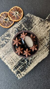 Chocolate tart or dessert with fruit and nuts. Sweet pastries on a dark concrete background