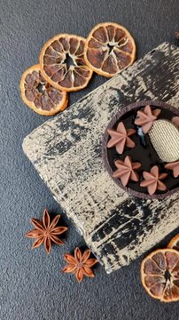 Chocolate tart or dessert with fruit and nuts. Sweet pastries on a dark concrete background