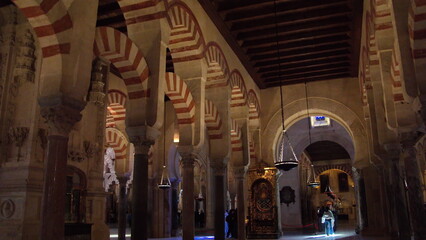 Columns and red and white arches supporting the ceiling in the Mosque-Cathedral of Cordoba, in the historic center of Cordoba, Spain