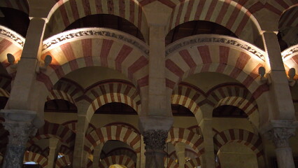 Columns and red and white arches supporting the ceiling in the Mosque-Cathedral of Cordoba, in the historic center of Cordoba, Spain