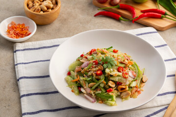 Spicy Cucumber Salad.Ancient thai food,cucumber in chilli garlic lime sauce topping with dried shrimp and roasted peanuts.