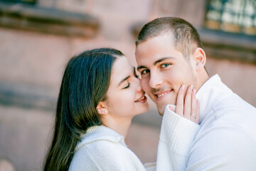Young beautiful couple in love, happy walking in small European town.