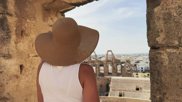 Woman Admiring the Ancient Amphitheatre of El Jem, Tunisia, in Bright Daylight