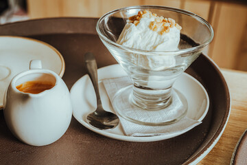 close-up photo of affogato, a preparation made with vanilla and peanut ice cream, to which hot espresso coffee is poured to generate contrast of flavors and textures in a Colombian coffee shop.