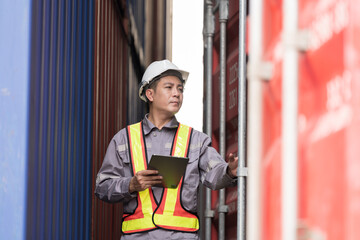 Import and export container, Worker inspecting and control of container. Male worker working and...