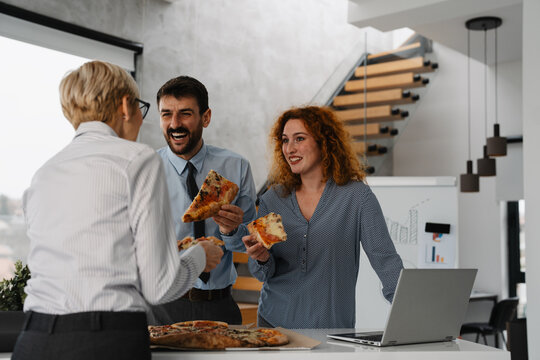 Business team eating pizza at lunch break
