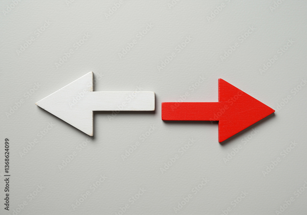 Poster arrows pointing in opposite directions show choice and decision making with white arrow pointing lef