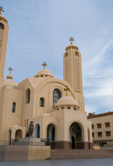  Exterior view of El Sama Ayen Coptic Orthodox Church in Sharm El Sheikh. Modern religious building with decorative crosses against the background of steel gates