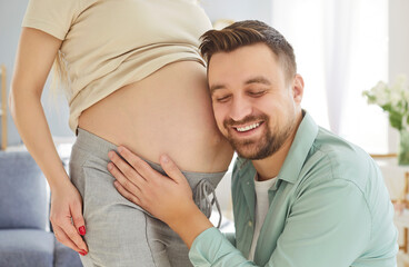 Listening sound in pregnant mother belly, happy future father expecting first baby close caring...