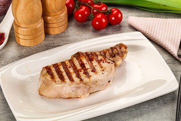 Grilled pork loin steak with bone