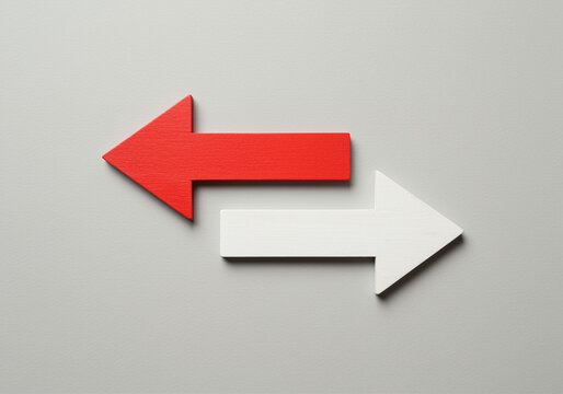 Arrows pointing in opposite directions on gray background showing directional arrows and graphic design. Red arrow pointing left and white arrow pointing right indicating direction and choice