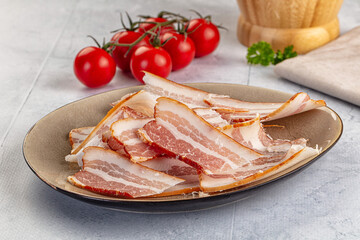 Raw pork tenferloin with bacon
