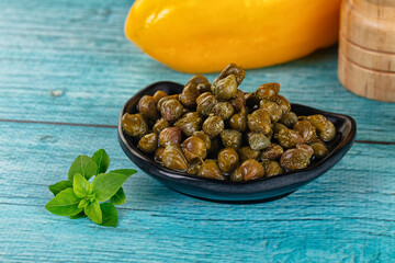 Pickled canned capers in the bowl
