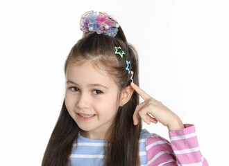Happy little girl wearing beautiful hair accessories on white background