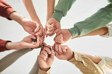 Unity, community and team work concept. Above view of unknown people keeping hands together in...