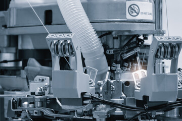 Industrial machine for embroidery of multi-colored threads on fabric