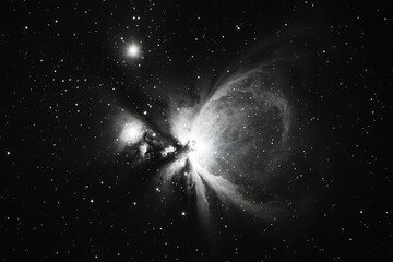 Obraz premium A monochrome image captures a nebula's ethereal beauty amidst a star-studded sky, showcasing intricate details of gas and dust.