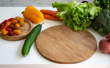 Bright culinary ingredients, vegetables and microgreens are laid out on the table near the wooden cutting board. Healthy Eating